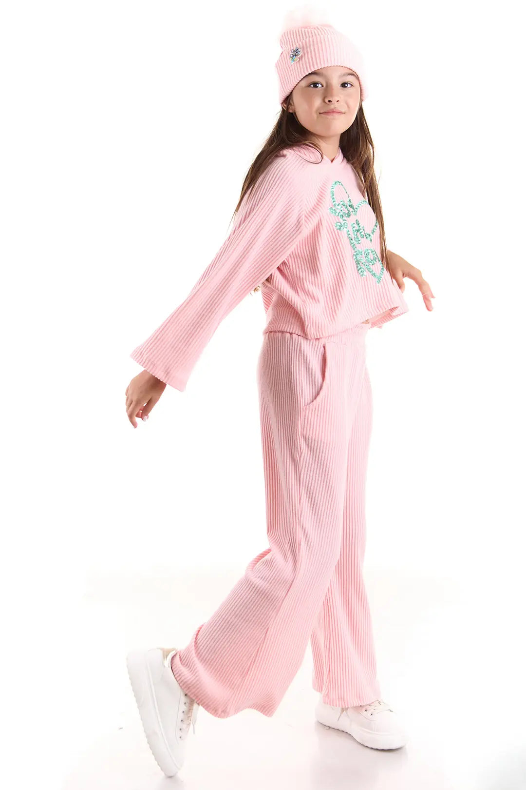 Child in pink outfit and hat